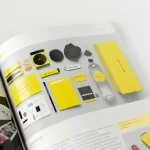 Book with yellow and black pages, featuring branding.