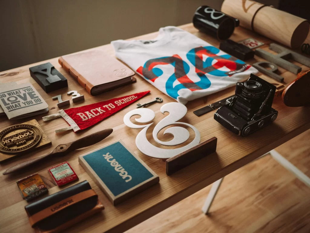 A table with assorted items on it, showcasing branding elements.