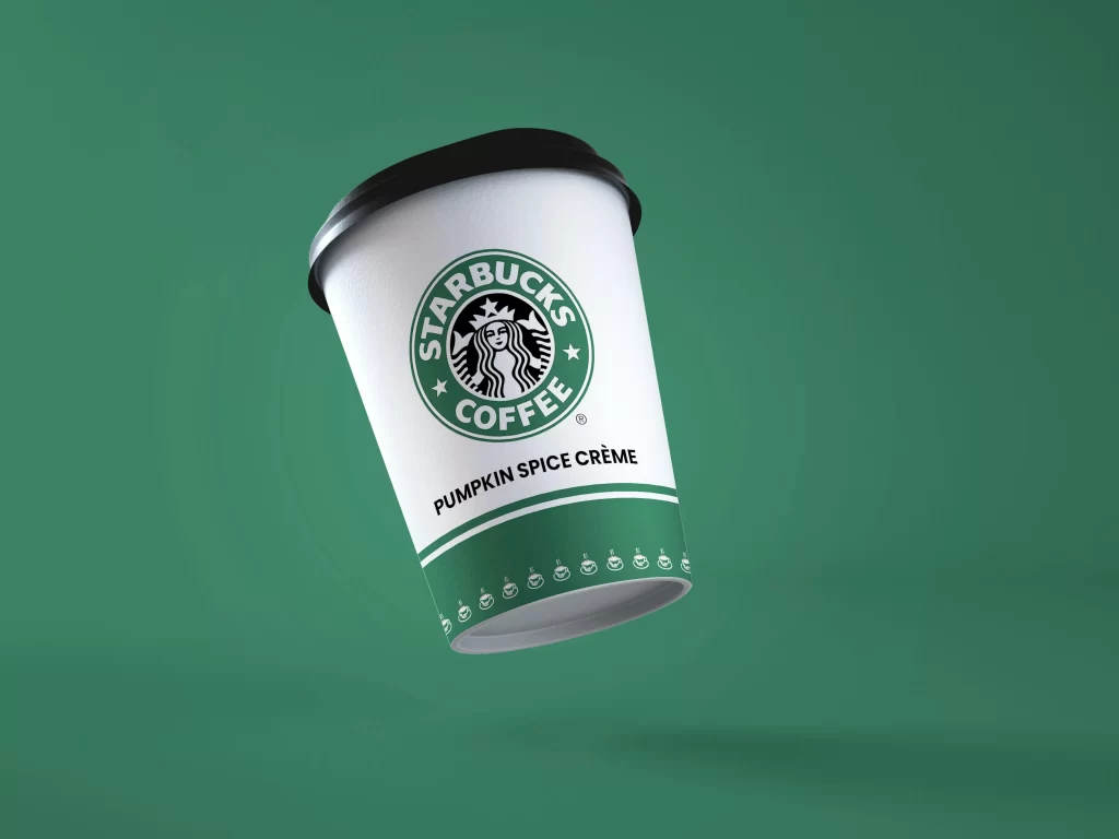 An image of a Starbucks cup, showcasing the recognizable branding, set against a vivid green backdrop.