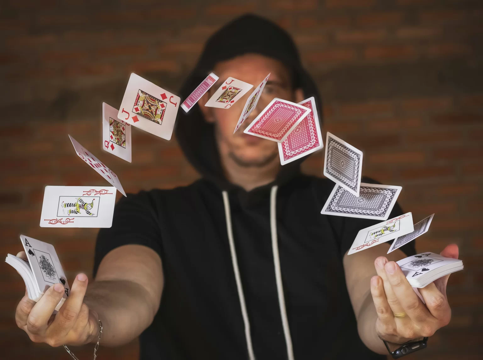 A magician doing a card trick, with cards fluttering in front of his face.  