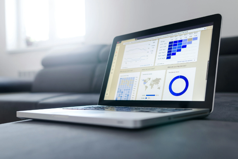 An open laptop with graphs shown on the screen. 