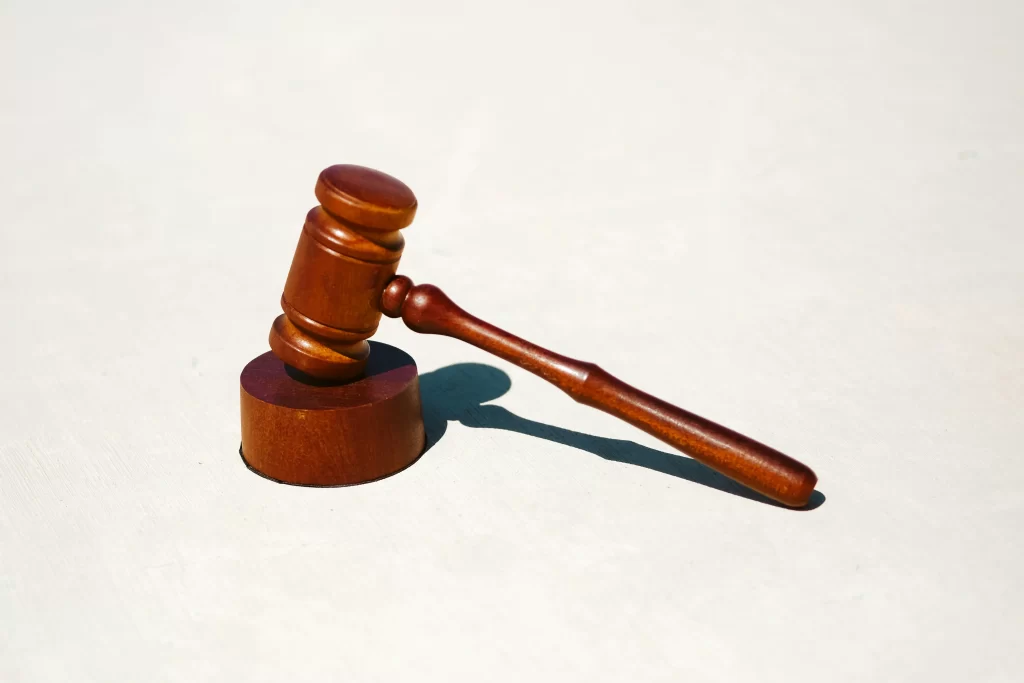 A brown gavel against a white background